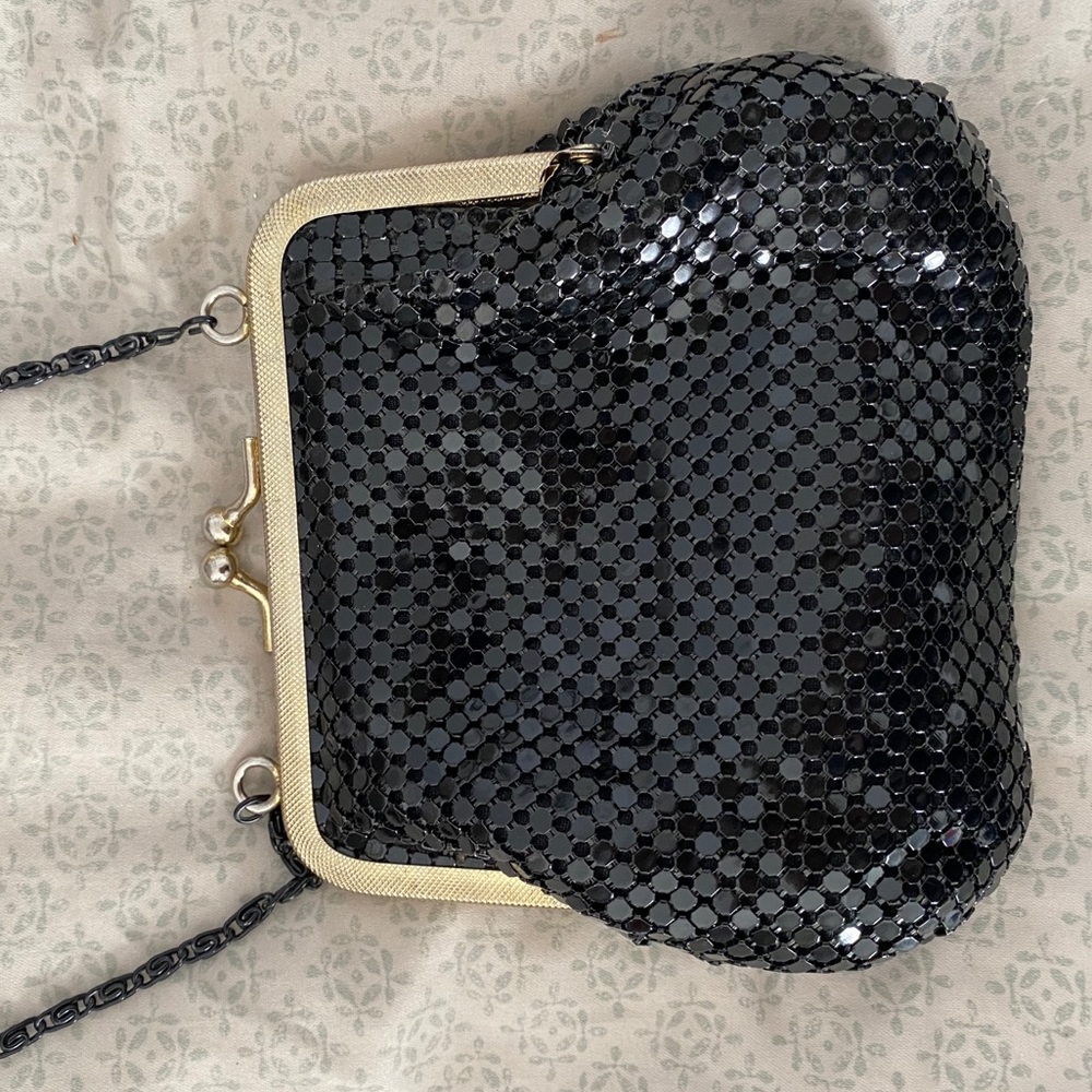 Black purse with gold accent.